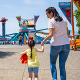 A mother and child walking in the Sesame Place Philadelphia park