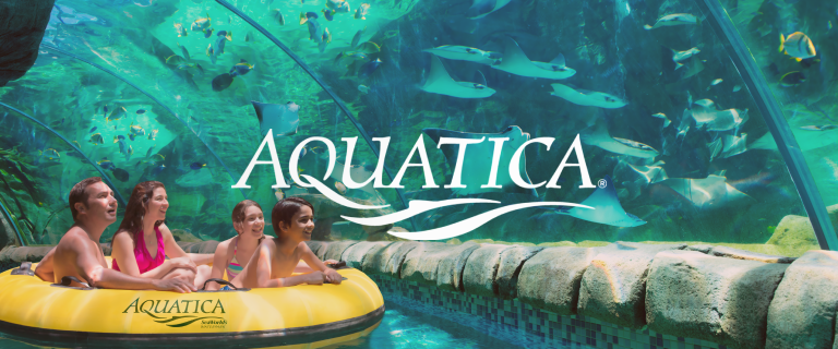 The Aquatica logo with a family in a raft floating through an arching aquarium