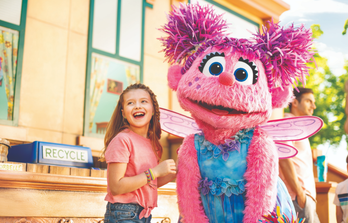 Abby and little girl at sesame neighborhood.