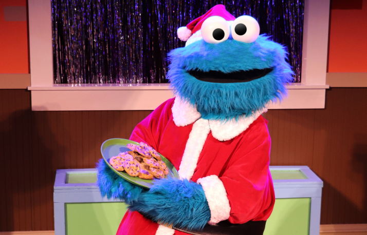 Cookie Monster dressed up as Santa.