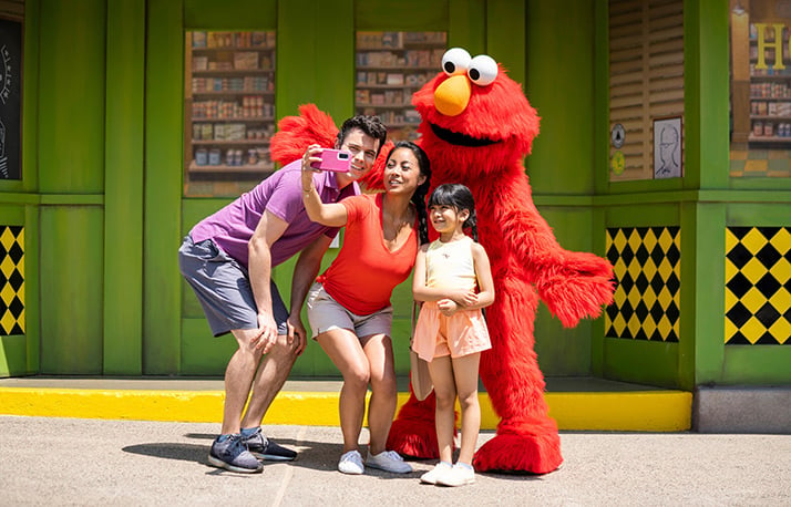 Elmo with family at park.