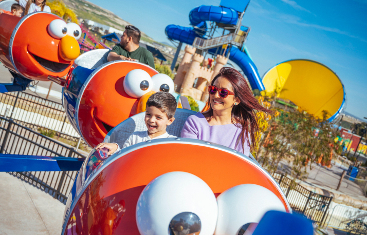 Child and woman on a Sesame Street themed ride