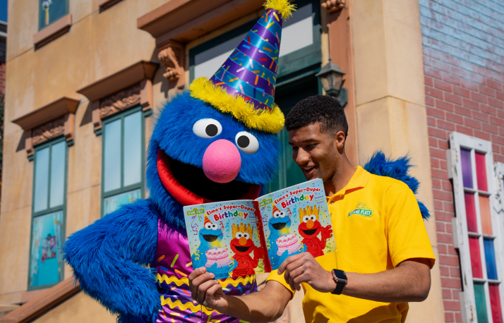 Grover and a man reading a Sesame Street birthday book