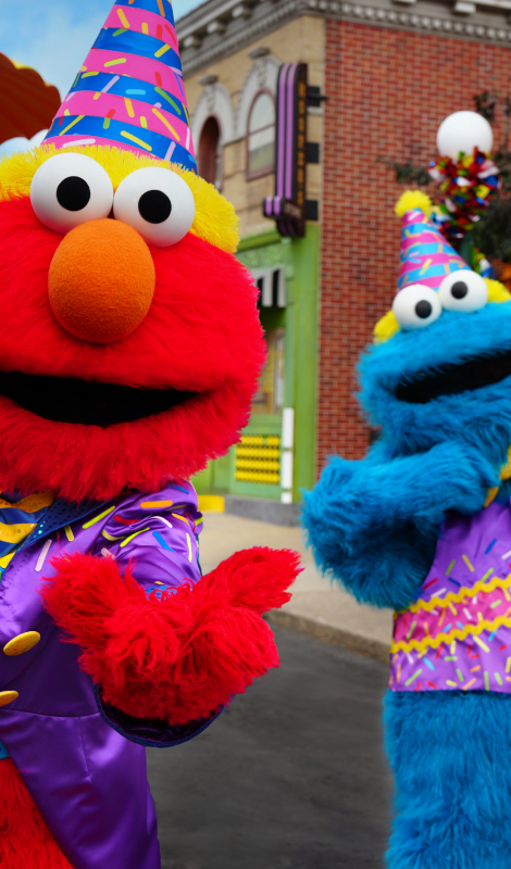 Elmo and Cookie Monster in birthday attire