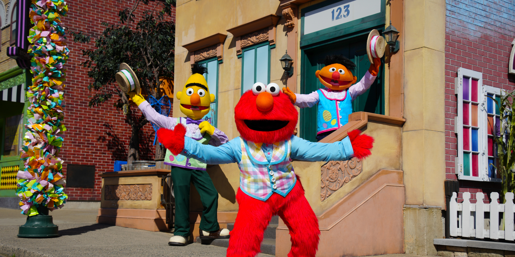 Bert, Ernie, and Elmo costumed characters on Sesame Street