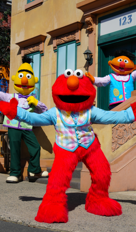 Bert, Ernie, and Elmo costumed characters on Sesame Street
