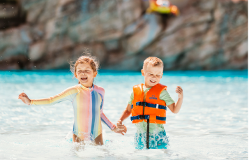Two kids playing at the big birds beach.